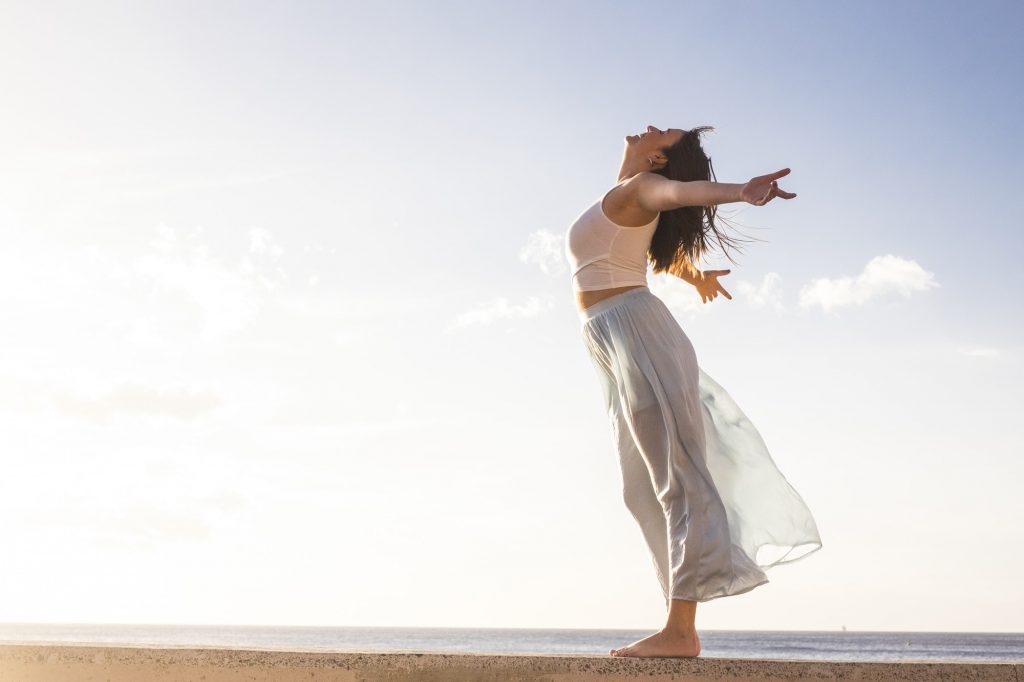 Freedom and empowerment female concept with young girl standing and enjoying